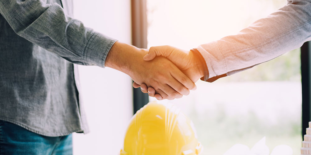 Project Manager or Sales Rep shaking hands with client